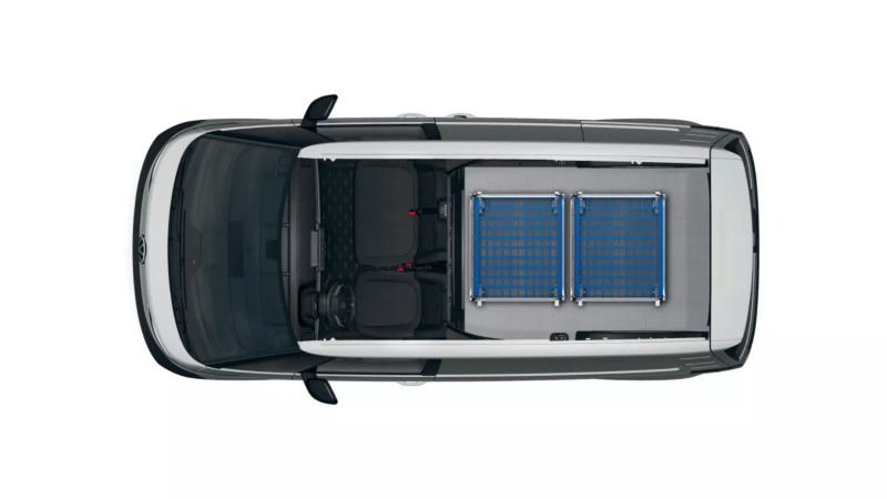 VW ID. Buzz Cargo z załadunkiem z kontenerów na kółkach.