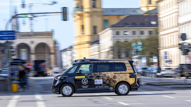 A self-driving VW ID. Buzz crosses an intersection.