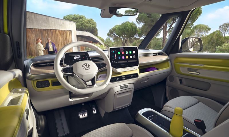 Intérieur du Volkswagen ID. Buzz vert clair avec vu sur le cockpit et le tableau de bord allumé.