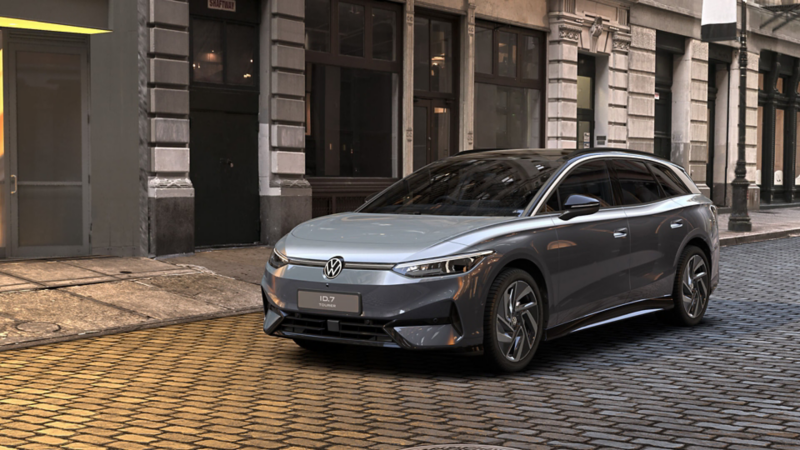 Front three-quarter view of an ID.7 Tourer parked on a cobbled street