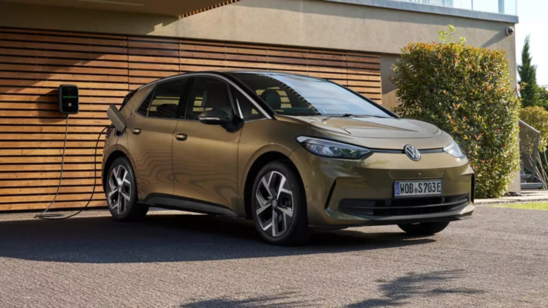 a bronze ID.3 parked at home plugged into a wall charger