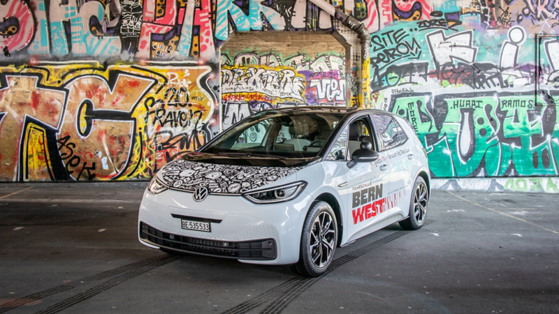Ein ID.3 vor einer Wand mit Graffitis