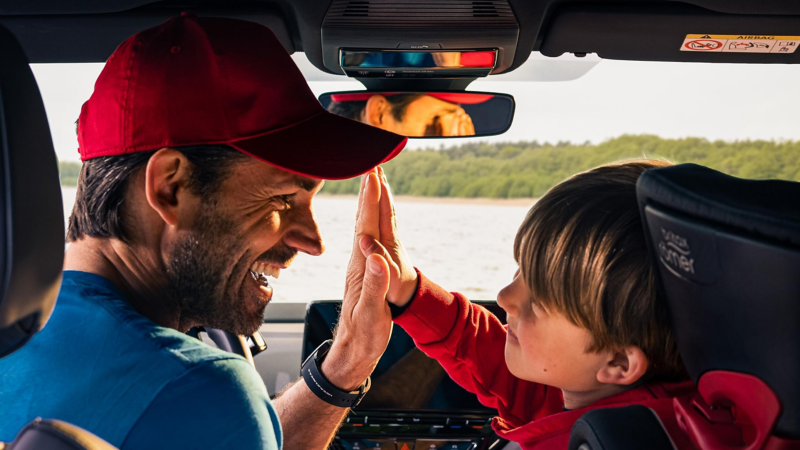 A man and a child high-fiving inside ID.4