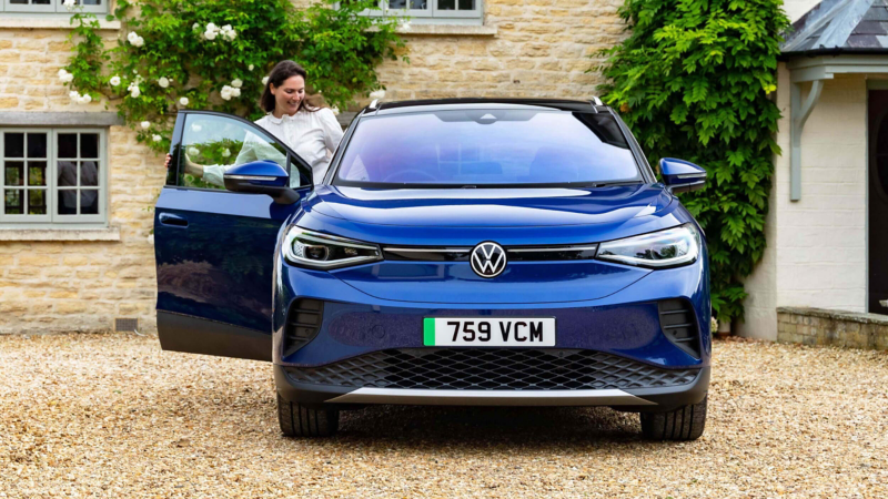 Exterior design of the Volkswagen ID. 4 parked next to a wall with a light display