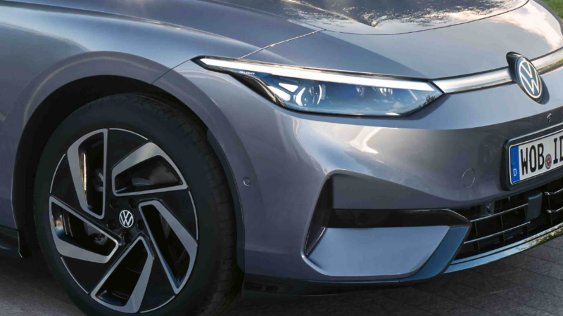 An up-close view of a wheel and front lights of a VW ID.7 Tourer