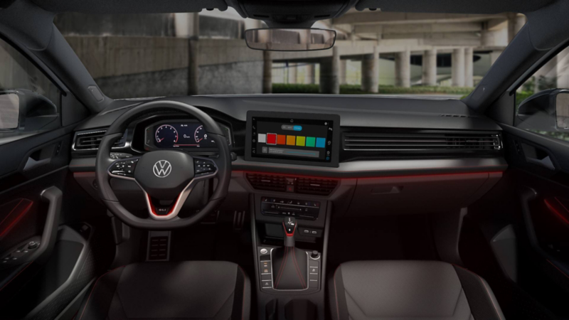 Interior de auto Volkswagen con pantalla que muestra colores de iluminación y luz roja activa. 