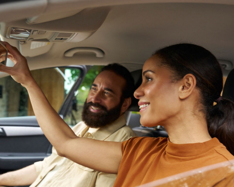 Man and woman in Volkswagen vehicle.