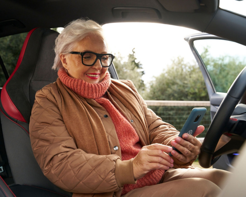 Woman using myQ connected garage via mobile app.