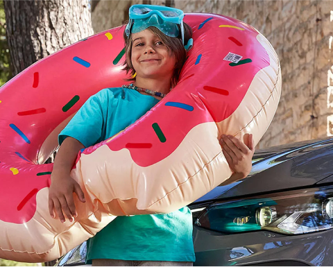 Girl with pool inflatable next to VW GTI.