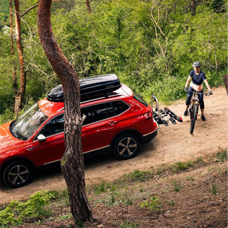 VW Atlas with mountain biker nearby.