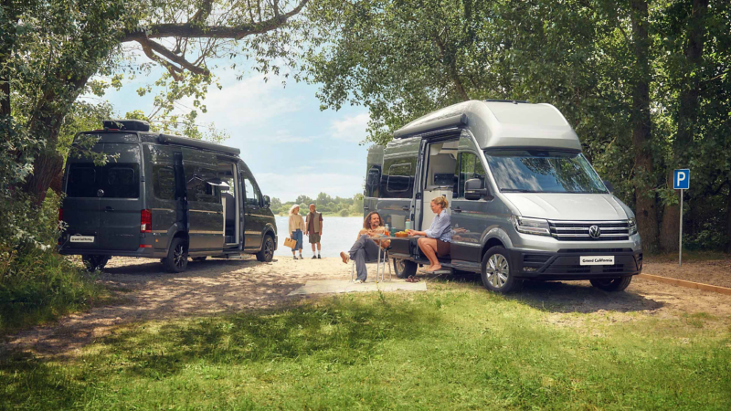 Two Grand California parked under trees