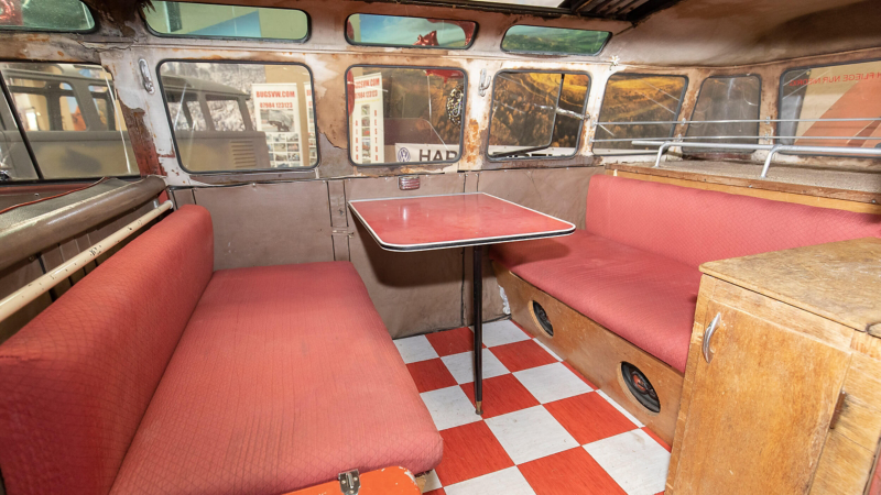 Photo showing the table area inside the rear section of a VW Samba van. 