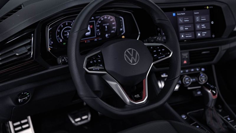 Interior de un sedán deportivo de Volkswagen, con pantallas digitales. 