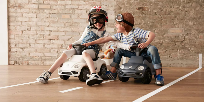 Deux enfants jouent ensemble avec leur voiture d'enfant Volkswagen Accessoires.