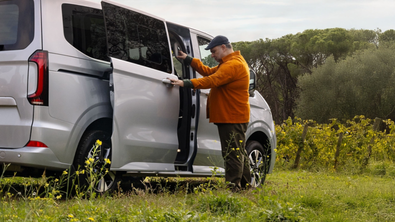 Tradespeople lash a marble slab on the load platform of a VW dropside.