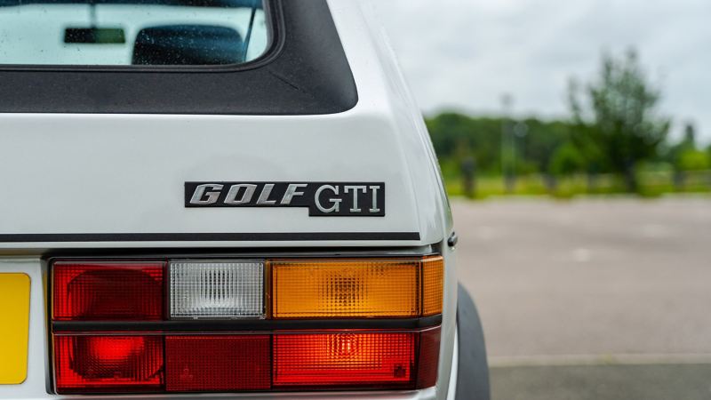 A rear shot of a silver Mk 1 VW Golf GTI focussed on the logo