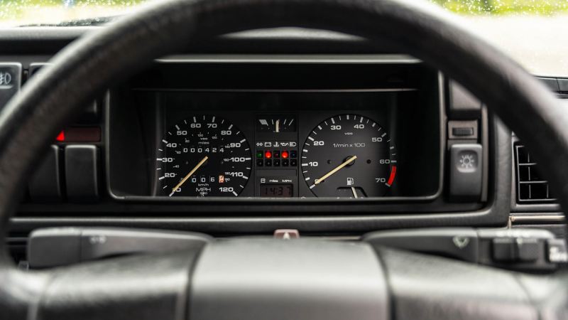 A close up of the steering wheel and speedometer in a Mk 2 VW Golf GTI