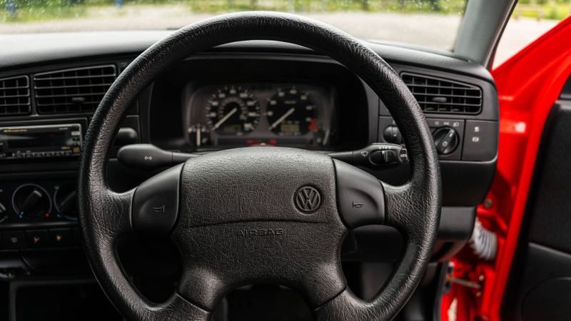 A close up of the steering wheel and speedometer in a Mk 3 VW Golf GTI