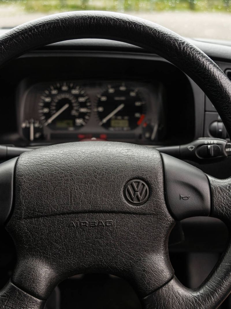 A close up of the steering wheel and speedometer in a Mk 3 VW Golf GTI