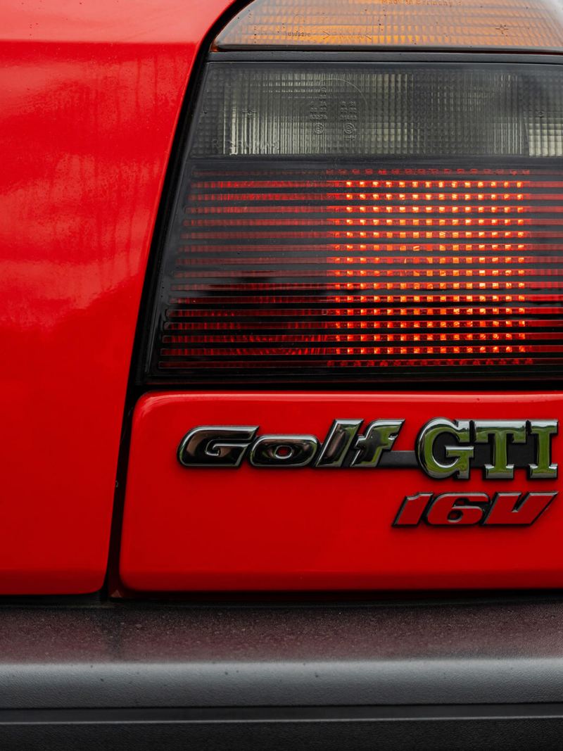 A rear shot of a red Mk 3 Golf GTI focussed on the logo