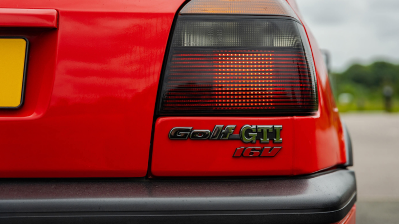 A rear shot of a red Mk 3 Golf GTI focussed on the logo