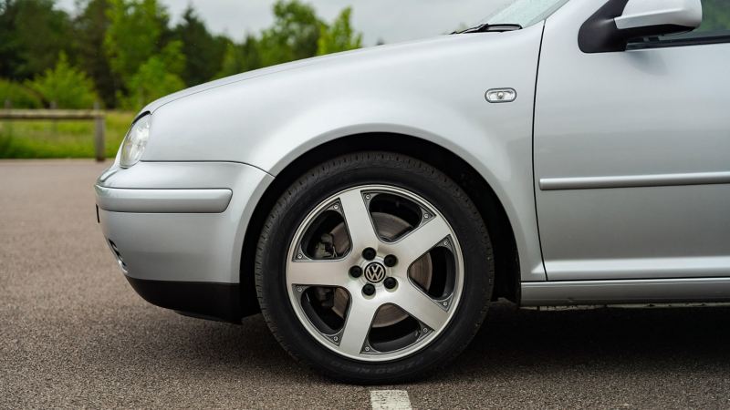 A side profile shot of a silver VW Mk 3 Golf GTI focussed on the wheel