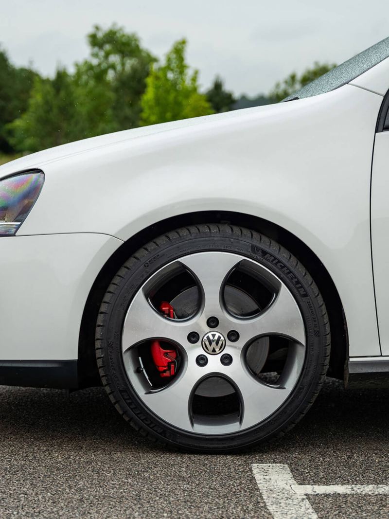 A side profile shot of a white Mk 5 VW Golf GTI focussing on the wheel