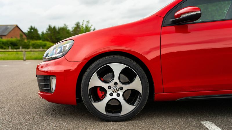 A side profile shot of a red Mk 6 VW Golf GTI focussing on wheel