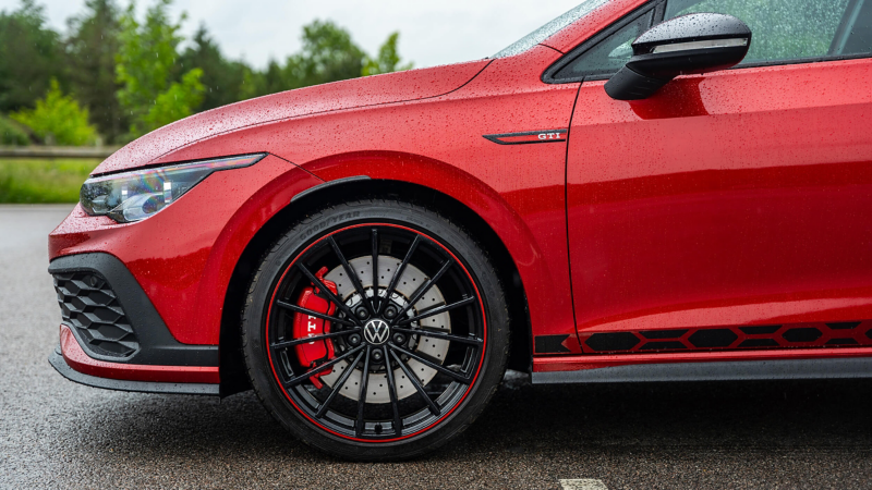 A side profile shot of a red Mk 8 VW Golf showing GTI logo and wheel