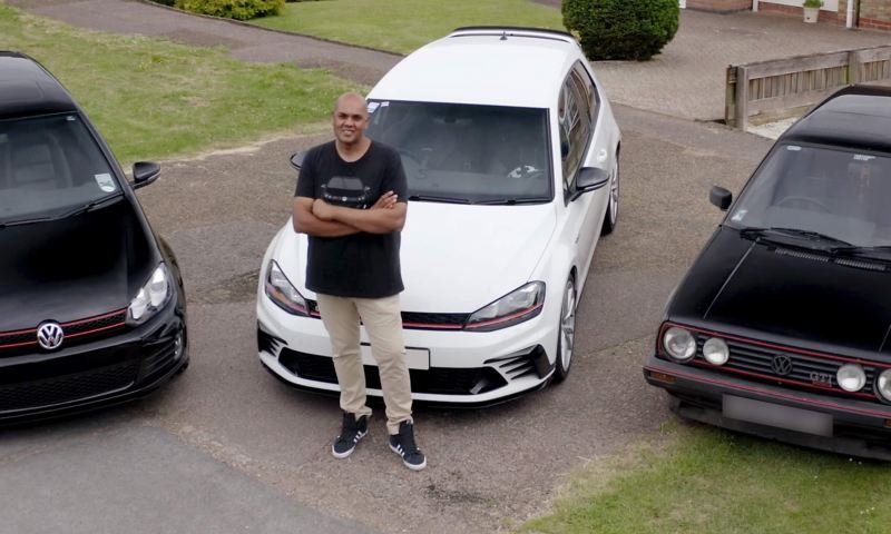 Chandrin stands in front of his Golf GTI collection