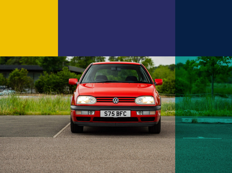 A red Golf mark 3 parked up surrounded by trees and fields