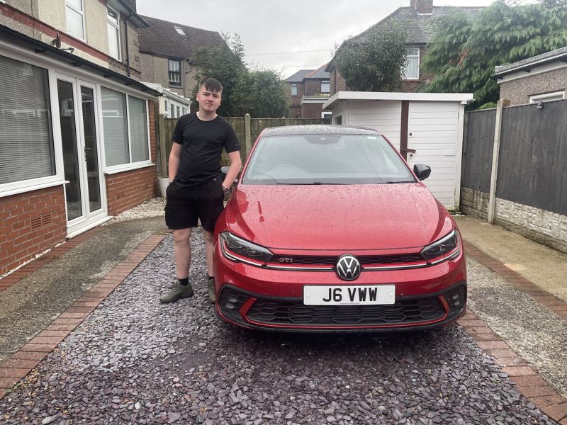 Man standing beside his parked Polo GTI