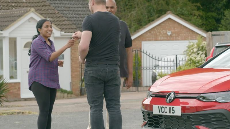 Ruwani and Chandrin being handed the keys to a 45th anniversary Golf GTI