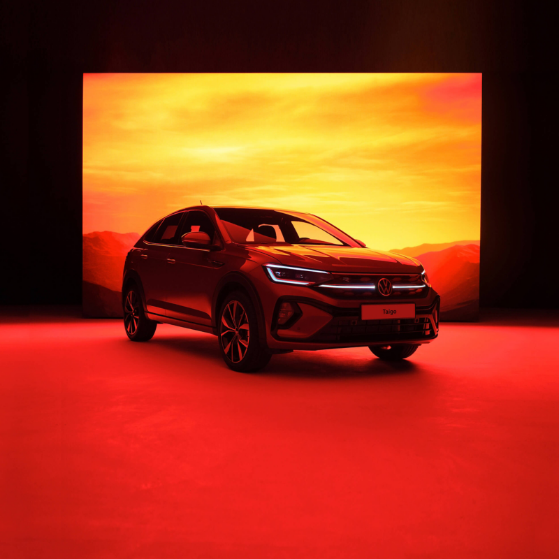 Red VW Taigo against a sunset background