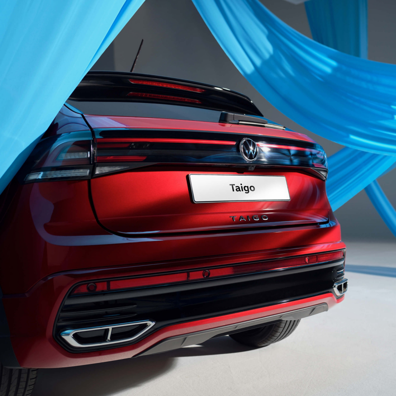 Rear shot of red VW Taigo surrounded by weaving blue ribbon