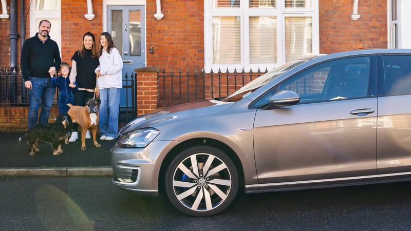 Woman with family happy with new Golf GTE