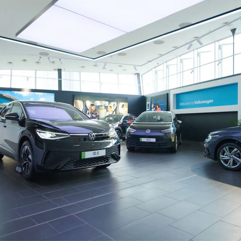 a number of Volkswagen electric cars in a showroom