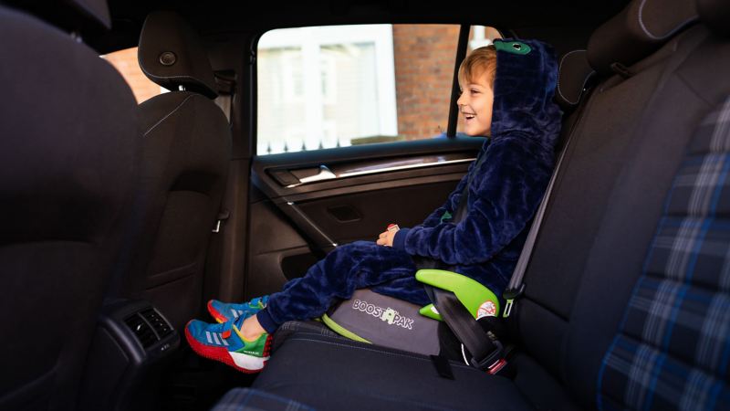 A young boy sat in a car seat in the back of a Golf GTE