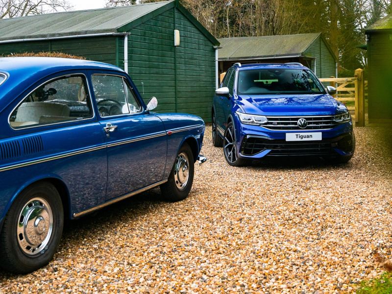 A blue retro VW next to the new Tiguan VW