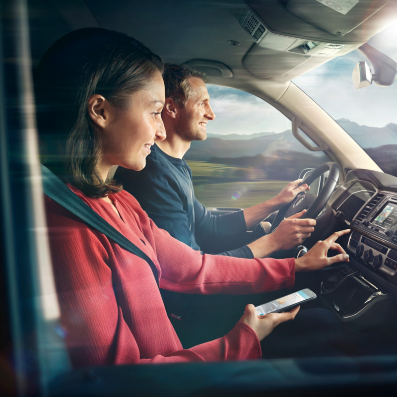 Two people in a vehicle cockpit.