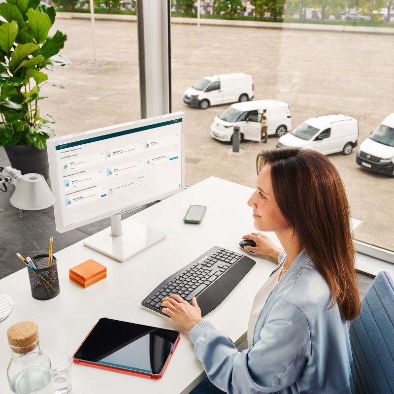 A office worker at a desk using a computer.