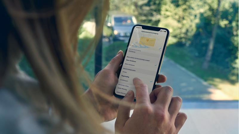 Eine Frau bedient ein Smartphone in ihrer Hand.