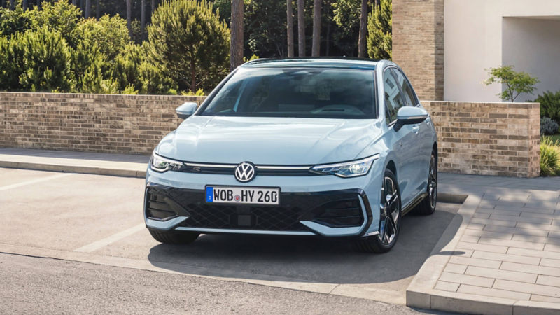 Une Golf Hybrid de face, garée devant un pavillon.