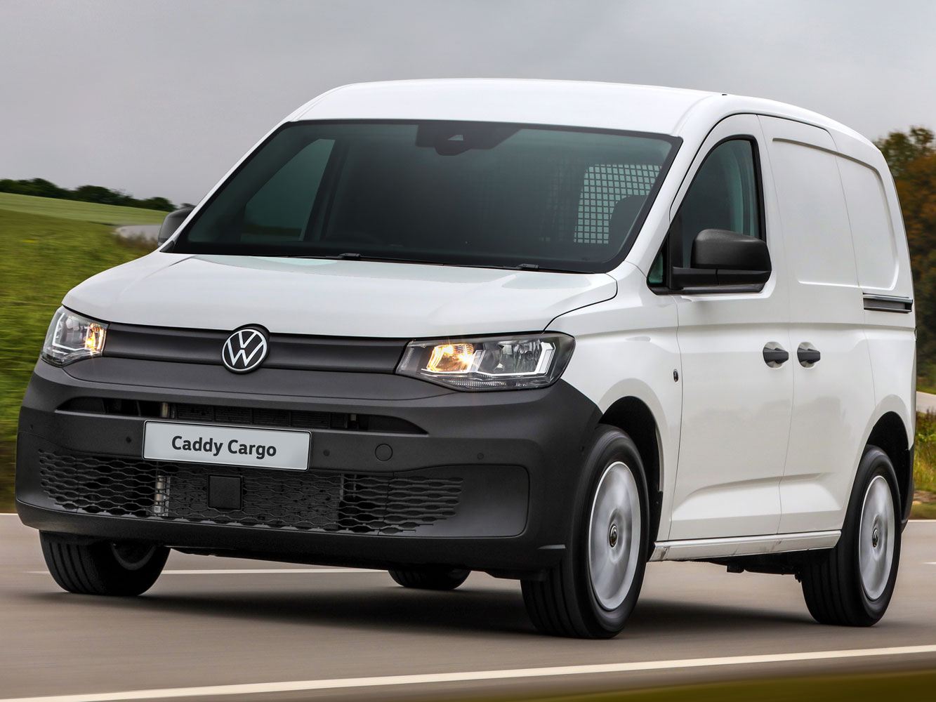 white-vw-caddy-cargo-driving-on-a-road-fast