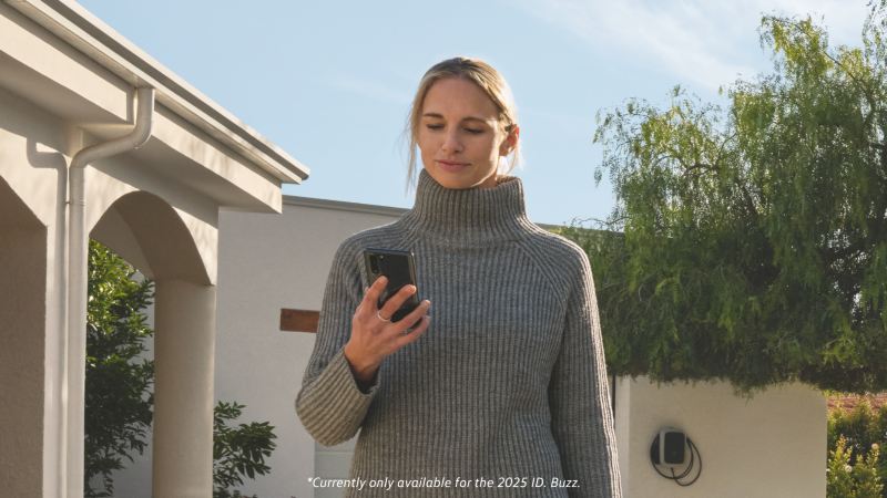 Woman using a smartphone app to remotely unlock her car.