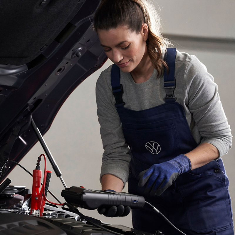 A technician servicing a Volkswagen vehicle