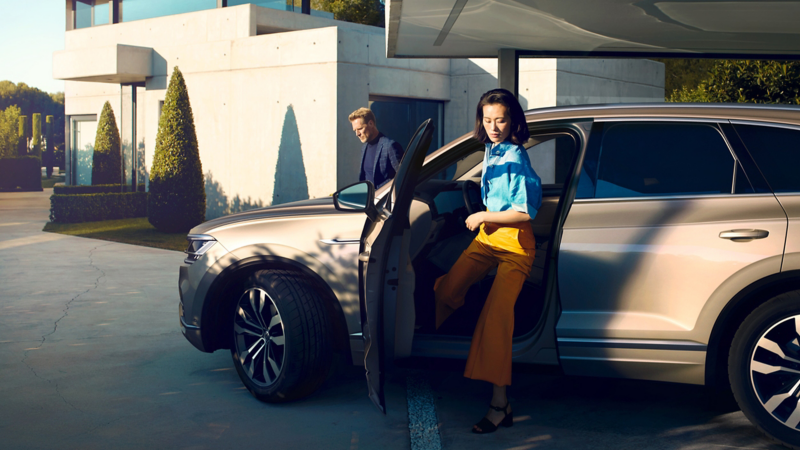 A woman stepping out of a Volkswagen vehicle