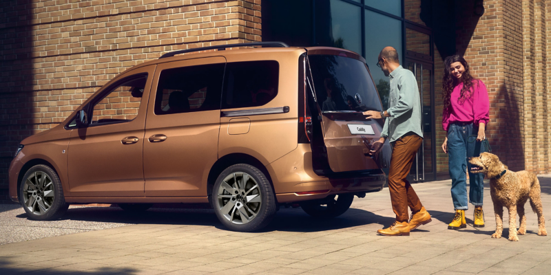 Side view of the new caddy with family and dog