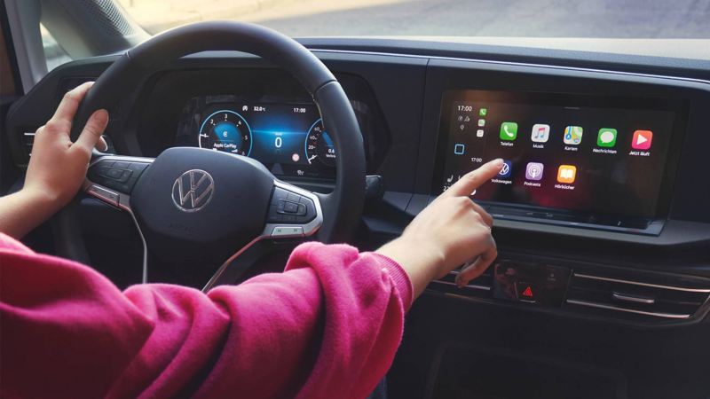 person using the touchscreen inside a new Caddy