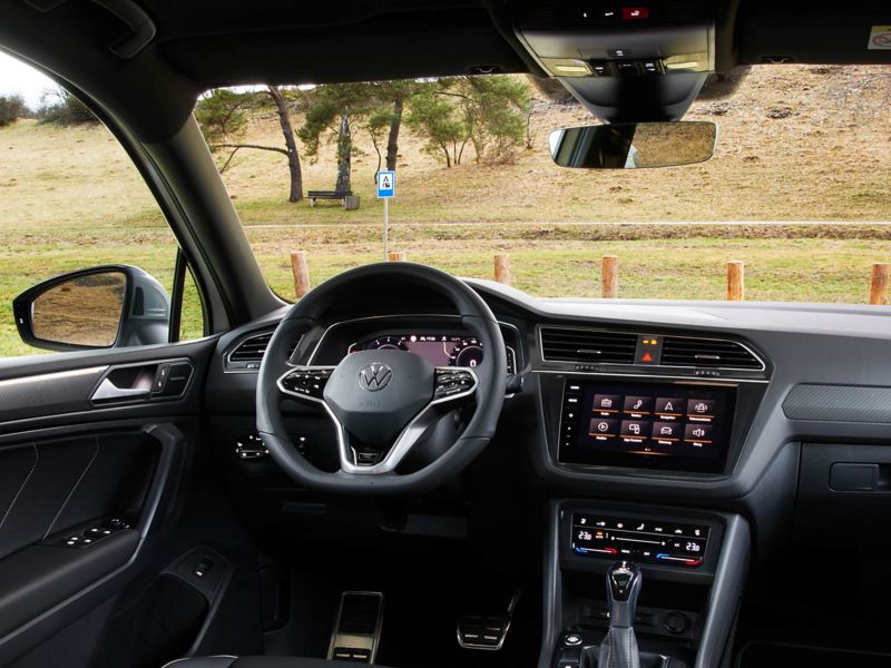 Interior shot of a Volkswagen Tiguan Allspace, steering wheel and dashboard.